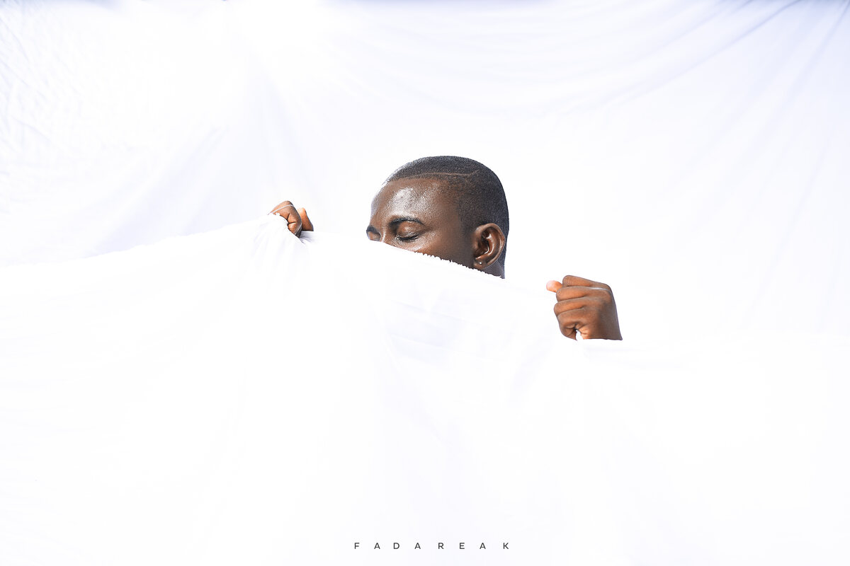 Conceptual portrait in white fabric