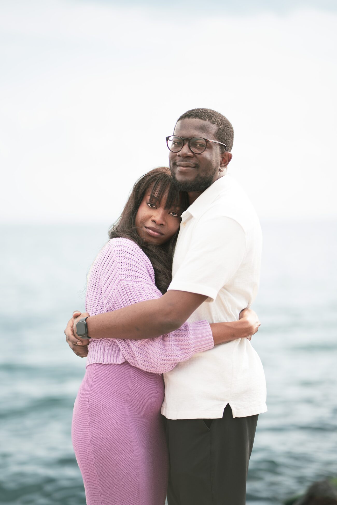 Couple embracing with the lake behind them