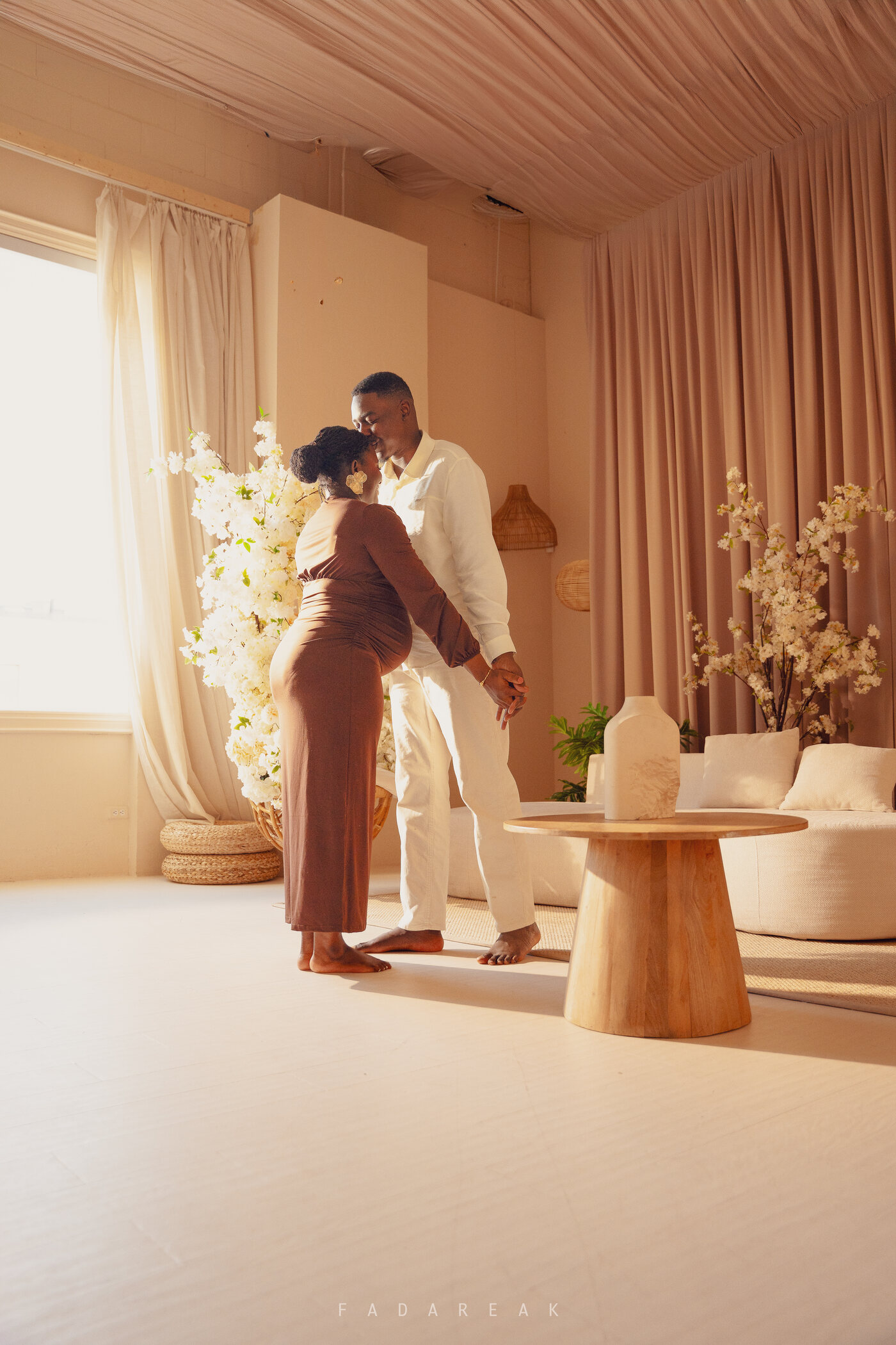 Expectant couple in a light-filled room