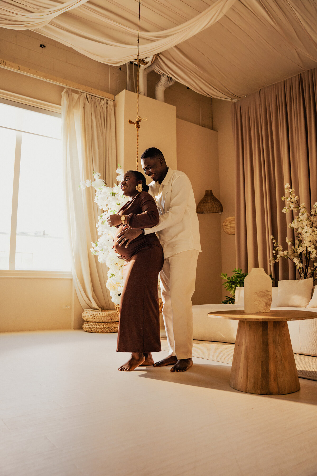 Expectant couple by a sunlit window